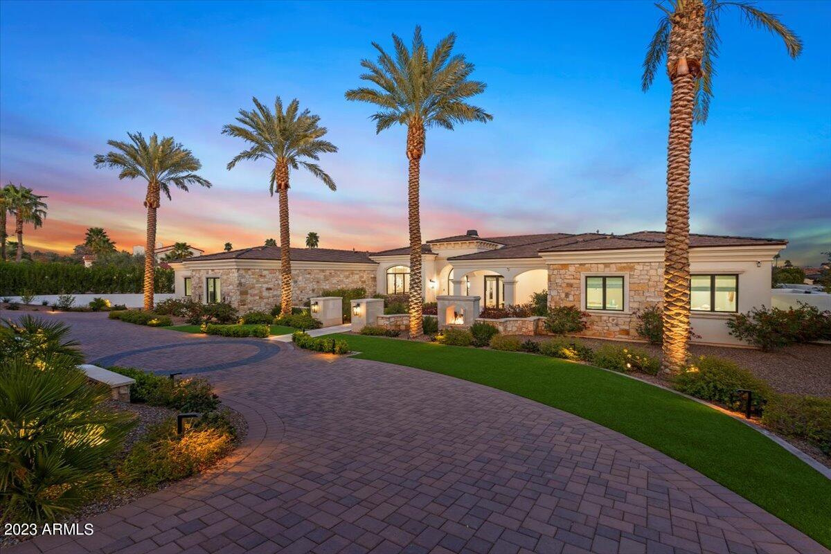 Private gated entry with circle drive and wall of ficus trees for additional privacy