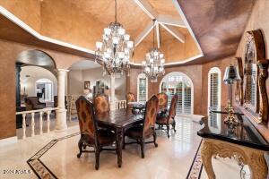 Formal dining with custom chandeliers and custom ceiling detail