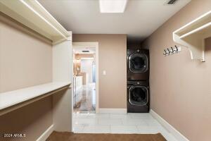 Primary suite closet with stackable washer and dryer