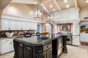 Large island with custom cabinetry and granite counter tops