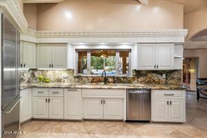 Kitchen window overlooking backyard paradise