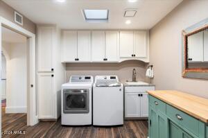 Laundry room with cabinets and sink