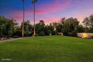 Large grass play area with plenty of room to add a pickle ball or sport court