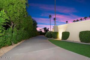 Long private driveway with 3 car garage tucked away
