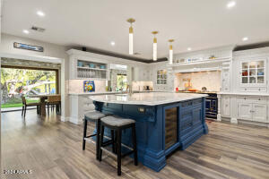 OVERSIZED KITCHEN ISLAND WITH MARBLE COUNTERTOPS